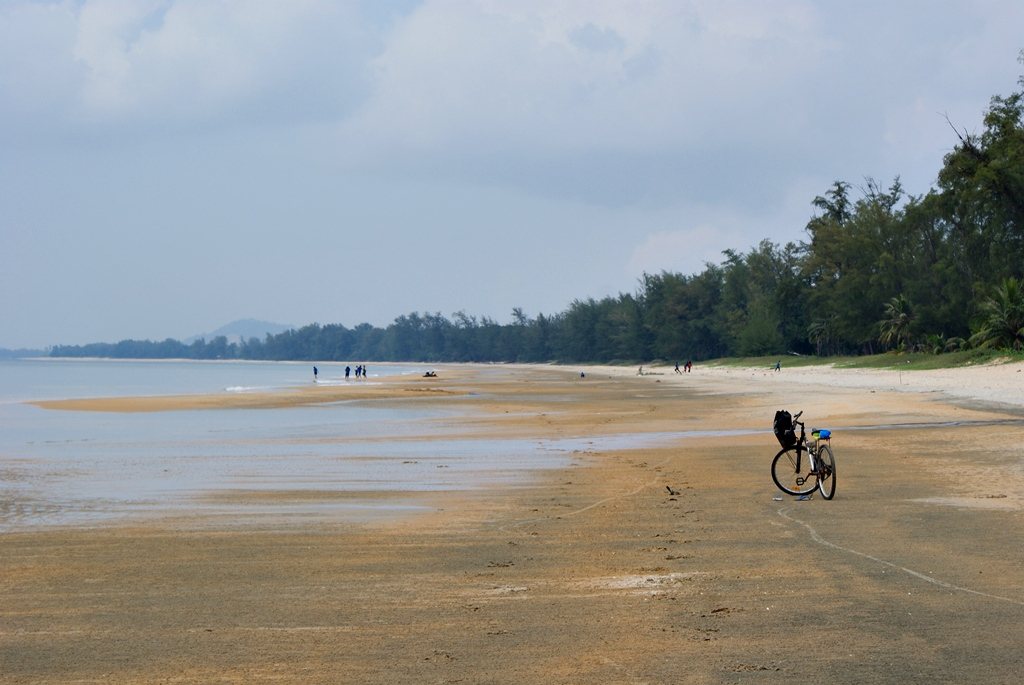 The broad white-sand beach at Cherating with coconut palms along the shore